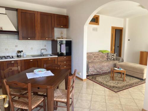 a kitchen and living room with a table and a couch at Villa Gianna in Limone sul Garda