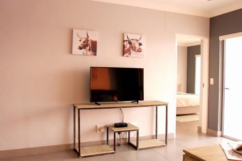 a living room with a flat screen tv on a wall at Atlantic Dunes Unit 10, Self Catering in Rand Rifles