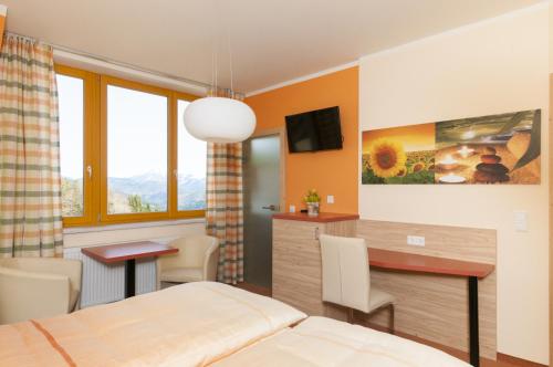 a bedroom with a bed and a desk and a table at Höhenstein in Lunz am See
