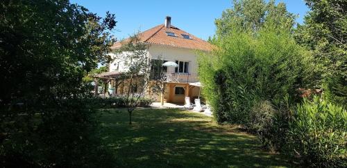 a large house with a yard with trees at Superb contemporary 3 bed villa in Cancon