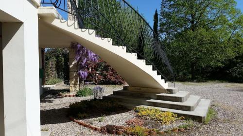a staircase in a garden with purple flowers at Superb contemporary 3 bed villa in Cancon