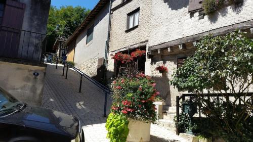 a building with flowers on the side of it at Superb contemporary 3 bed villa in Cancon