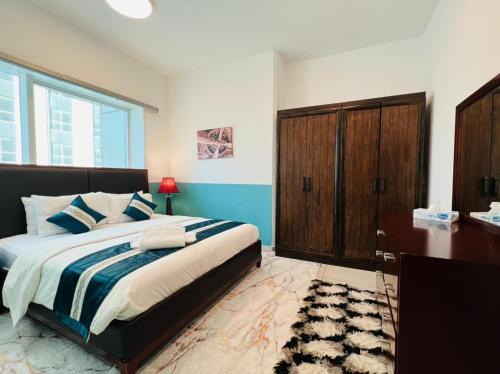 1 dormitorio con 1 cama grande, escritorio y vestidor en skynest holiday homes 1bedroom apartment 4003, en Dubái