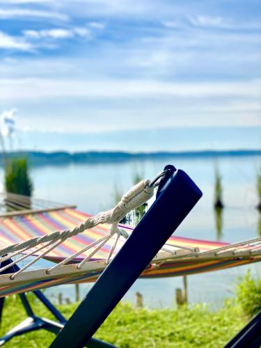 a bench with a rope on it next to the water at Navigator Hotel i Konferencje in Zbąszyń