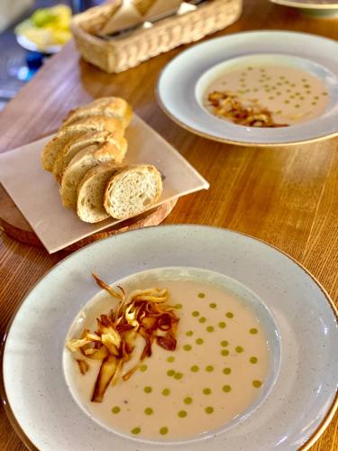 a table with three plates of food and bread at Navigator Hotel i Konferencje in Zbąszyń