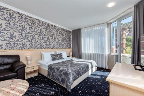מיטה או מיטות בחדר ב-Sharden Hotel