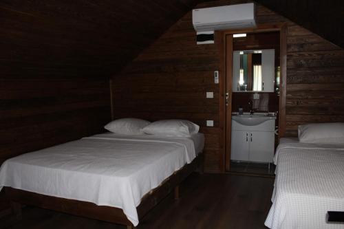 a bedroom with two beds and a sink in it at Zeytindağı bungalow in Mehmetalanı