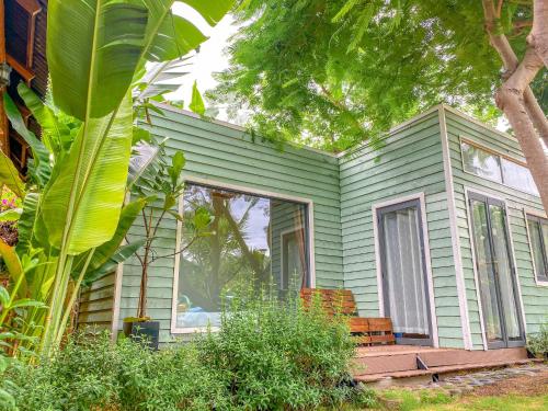 a green house with a porch and a window at Long Hải Channel Beach Resort in Long Hai