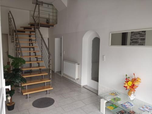 a hallway with a spiral staircase in a house at Ferienwohnung Jasmin in Rust