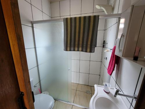 a bathroom with a shower and a toilet and a sink at Casa Mirante Bixo Do Mato in Muçum