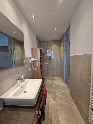a bathroom with a sink and a shower at Alpenchalet Melanie - inklusive Silvretta Card Premium in Galtür