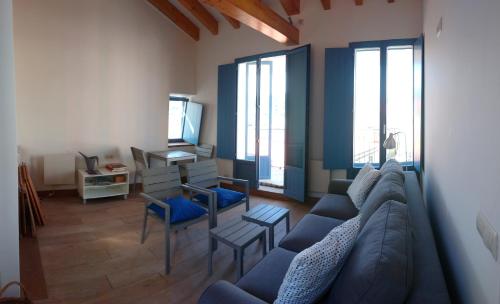 a living room with a blue couch and a tv at Campo da Lúa 4 in Muros