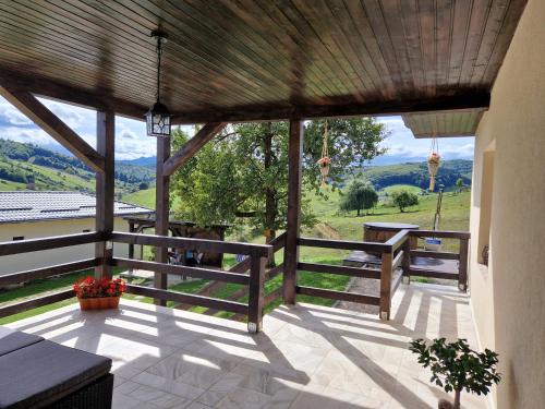 a large porch with a view of the mountains at Complex Dealu' Frumos in Întorsura Buzăului