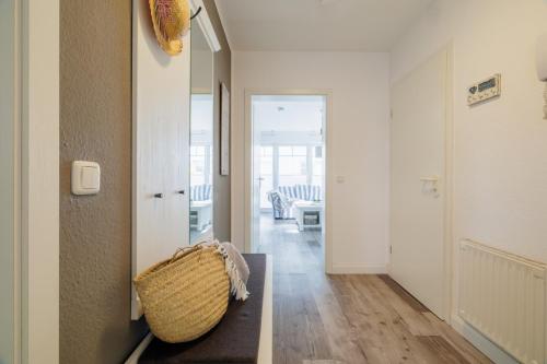 a living room with a hallway with a couch and a hallway at Boddenkieker 12 in Zingst