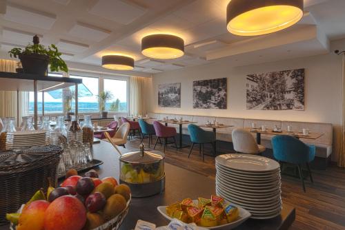 a dining room with a table with fruit on it at Hotel Pfefferburg in Schönaich