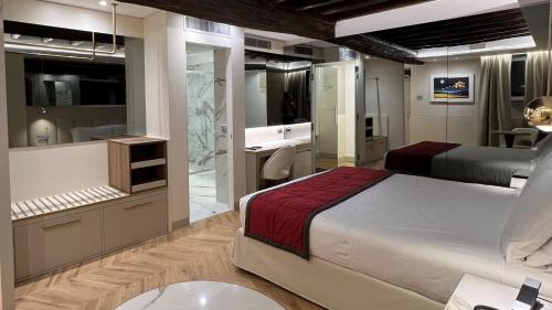a bedroom with a bed and a bathroom at Harry's Bar Trevi Hotel & Restaurant in Rome