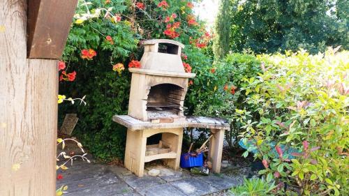 a outdoor oven sitting in the middle of a garden at Superb contemporary 2 bed villa +private pool in Cancon