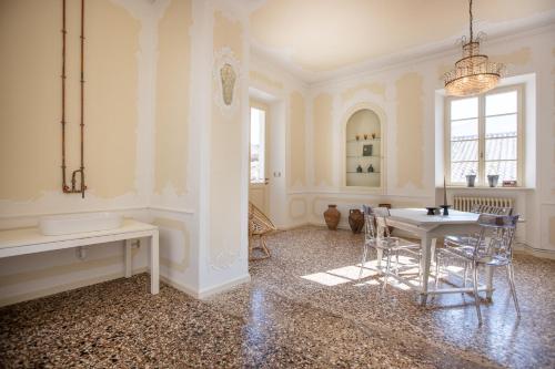 a white room with a table and chairs in it at Villa Sizzo Relais B&B in Trento