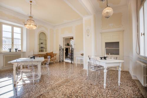a room with two tables and chairs in it at Villa Sizzo Relais B&B in Trento