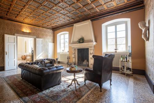 a living room with a couch and a fireplace at Villa Sizzo Relais B&B in Trento