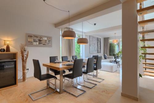 a dining room and living room with a table and chairs at Villa Kate Istria in Žminj