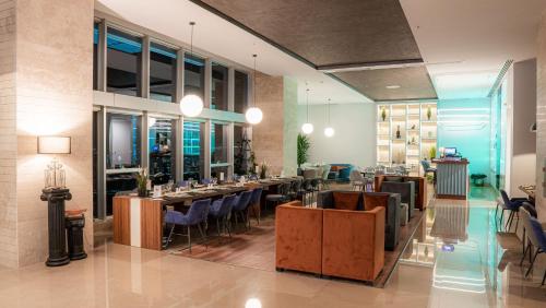 a restaurant with tables and chairs in a room at Dedeman Konya Hotel Convention Center in Konya