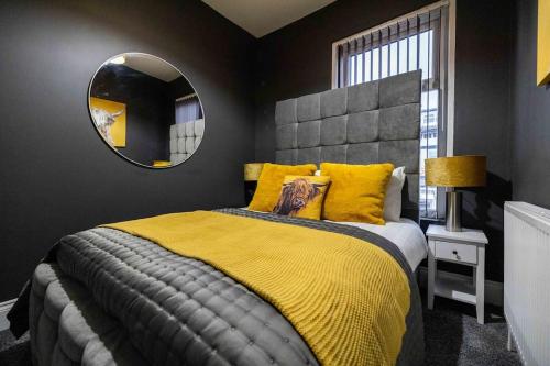 a bedroom with a large bed and a mirror at Regent Road by the V Group in Blackpool