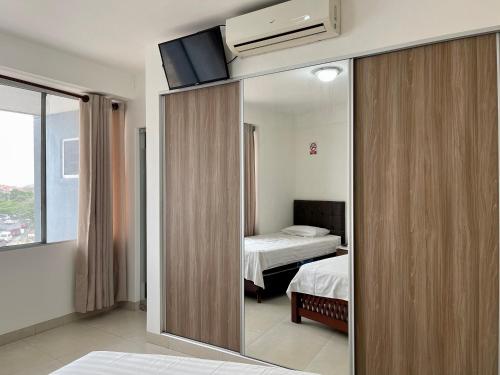 מיטה או מיטות בחדר ב-Edificio Las Palmas 3100