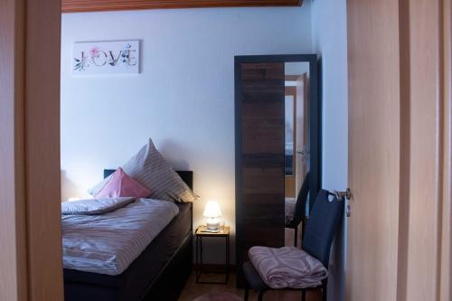a small bedroom with a bed and a mirror at Gästewohnung Mönchengladbach in Mönchengladbach