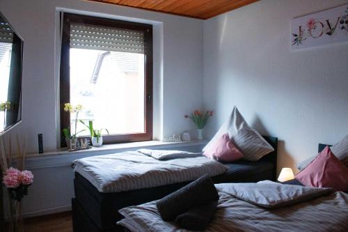 a room with two beds and a window at Gästewohnung Mönchengladbach in Mönchengladbach