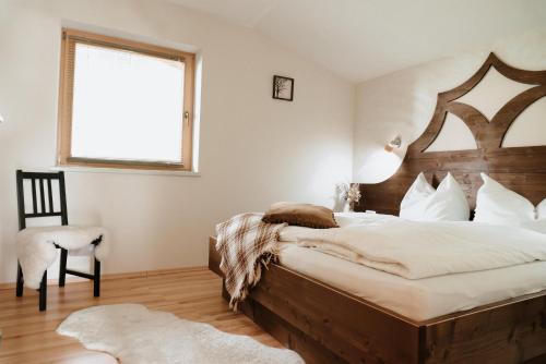 a bedroom with a large bed with a wooden headboard at Astegg, Apart in Finkenberg