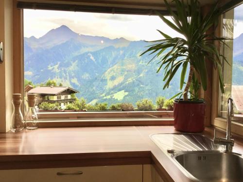 a kitchen window with a view of a mountain at Astegg, Apart in Finkenberg