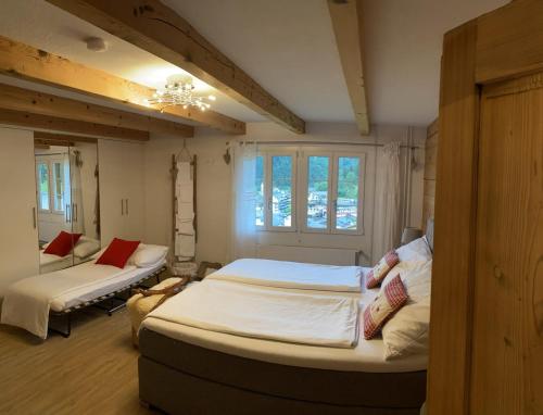 a bedroom with two beds and a window at Ybrig Lodge in Unteriberg