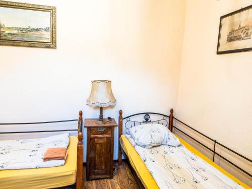 two beds in a room with a lamp on a table at Bocianówka in Baranów Sandomierski