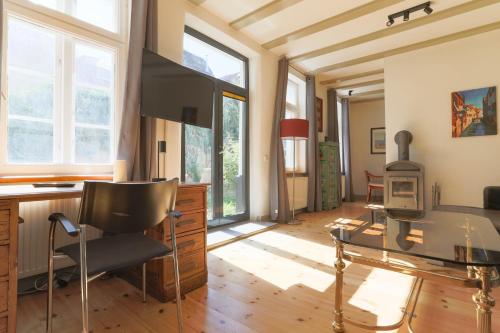 a living room with a glass table and a chair at Apartments im Einhornhaus in Lübeck