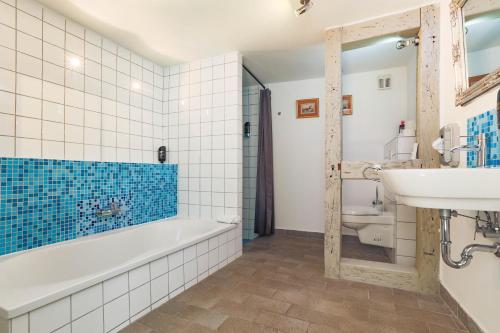 a bathroom with a tub and a sink at Apartments im Einhornhaus in Lübeck
