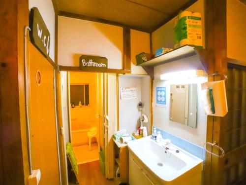 uma pequena casa de banho com um lavatório e um espelho em Guesthouse TOKIWA - Vacation STAY 01074v em Fujinomiya