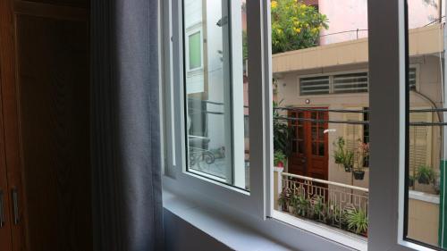 an open window with a view of a balcony at 102 House in Ho Chi Minh City