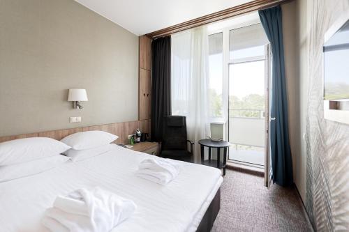 Postel nebo postele na pokoji v ubytování SPA VILNIUS Druskininkai