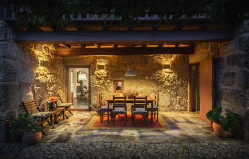a stone house with a table and chairs at Casa Castel'Rei in Guimarães