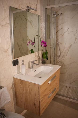 a bathroom with a sink and a shower at La Casetta in Agrigento