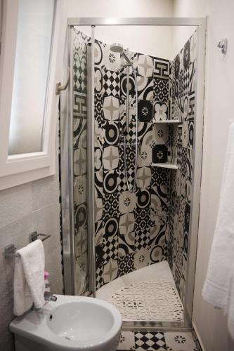 a bathroom with a shower with a toilet and a sink at La Casetta in Agrigento