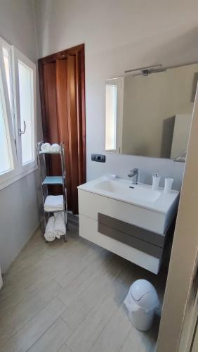 a bathroom with a white sink and a mirror at La Casetta in Agrigento