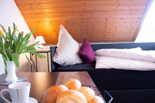 a living room with a couch and a table with bread at Gästewohnung Mönchengladbach in Mönchengladbach