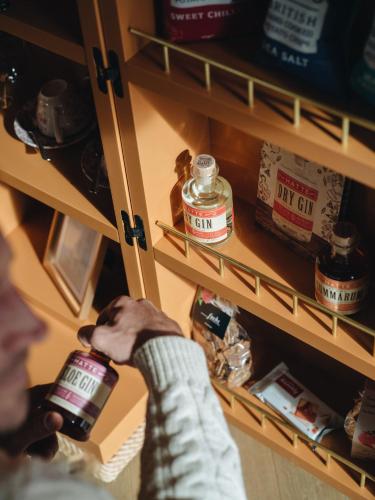 a person holding a jar of food in a pantry at BEAUSiTE Zermatt in Zermatt