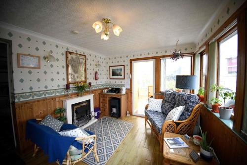 a living room with a couch and a fireplace at Grenitote B&B in Portree