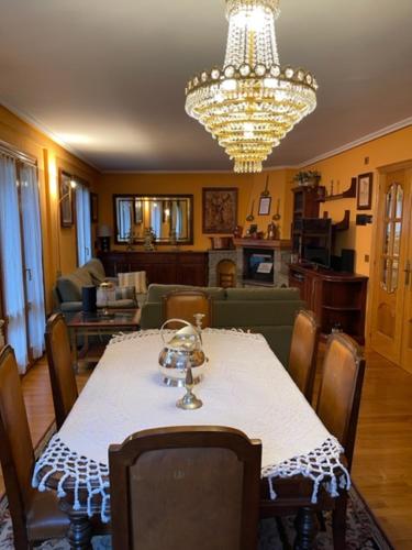 a dining room with a table and a chandelier at Casa Conchita de Benasque in Benasque