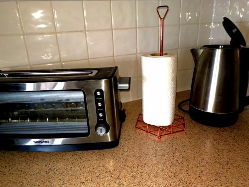 a kitchen counter with a microwave and a roll of paper towels at City Centre Penthouse in Southampton