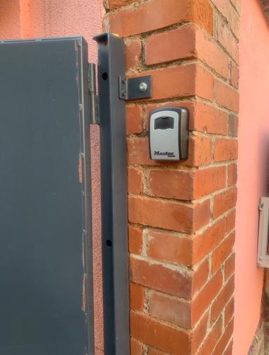 a door on a brick wall with a mailbox at L'instant T 4* Balnéo, Sauna et Parking Privé in Colmar