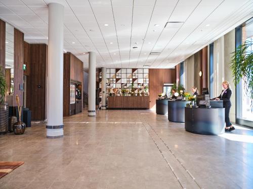 a lobby with a person standing at a desk at Quality Hotel Match in Jönköping